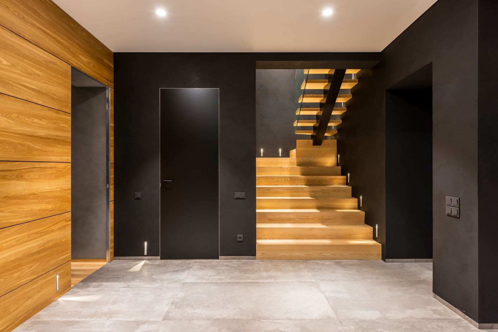 Spacious corridor with a wooden staircase