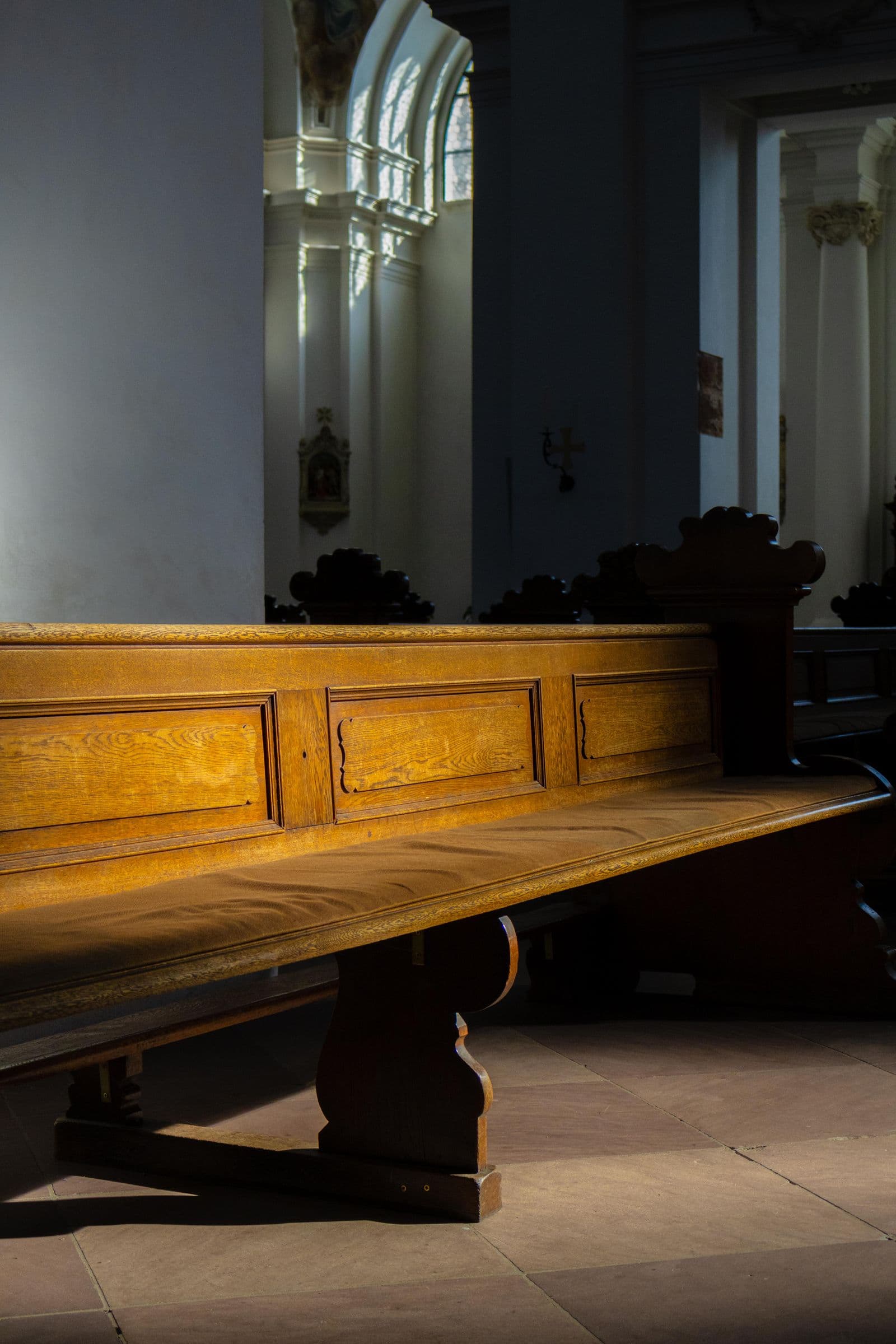 Classic church pew in a sunlit interior