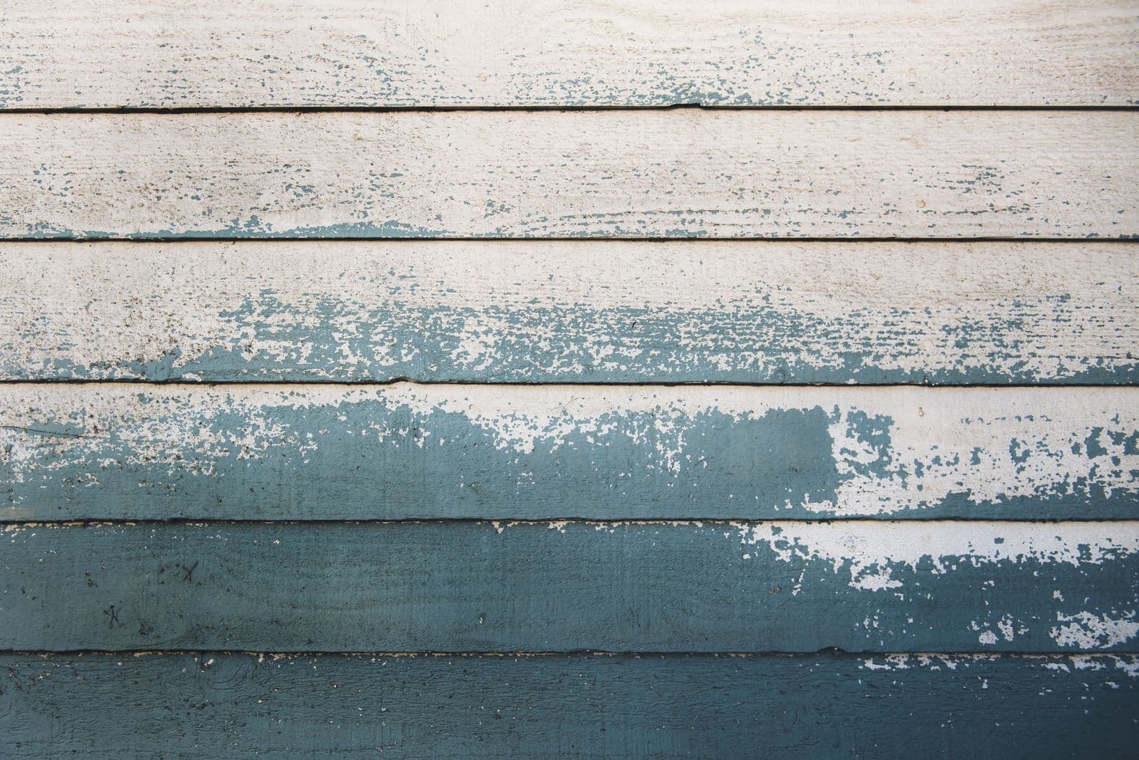 Gray wooden wall with worn paint
