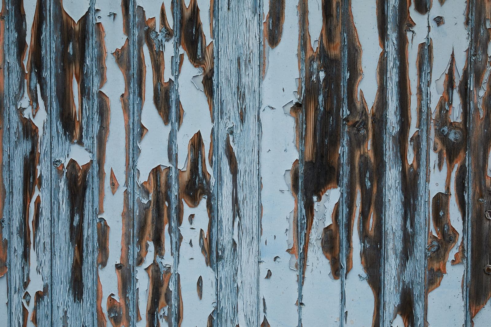 Wooden wall covered with peeling paint