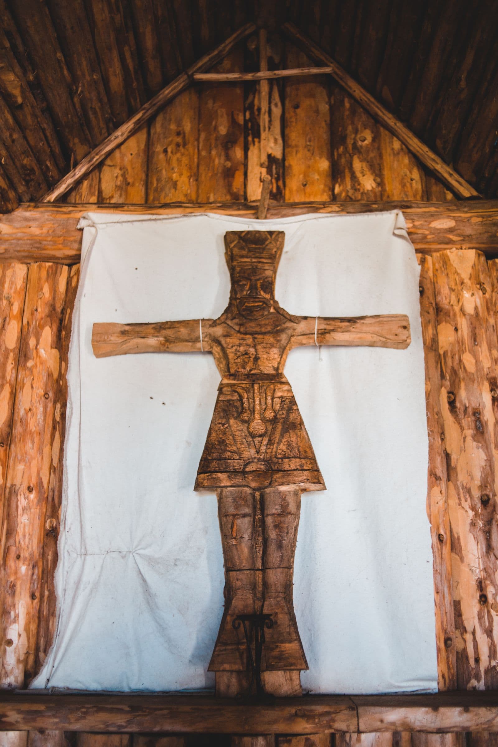 Old wooden cross inside a rustic church